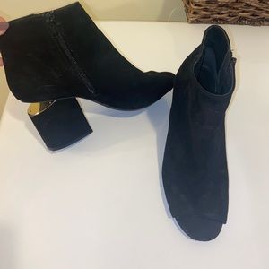 Black open toed booties with fun heel detail!